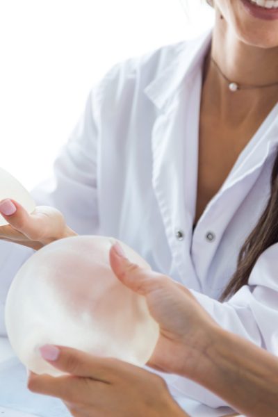 doctor-her-patient-choosing-mammary-prosthesis-office-min